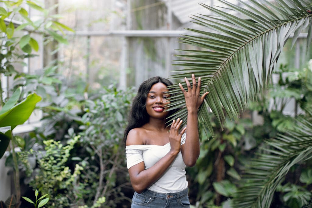 African woman model in tropical hothouse